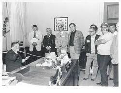 ["Black and white photograph print of Carl Albert in various poses with unidentified people."]