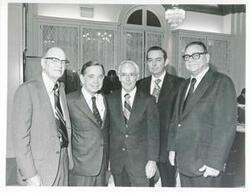 ["Black and white photograph print of Carl Albert posing with E.T. Dunlap and three others and an unidentified man."]