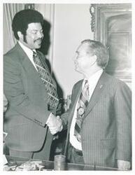 ["Black and white photograph print of Carl Albert shaking hands with Henry Butler. October 28, 1975"]