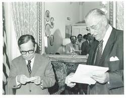 ["Black and white photograph print of Carl Albert standing next to Lewis Deschler."]