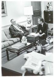 ["Black and white photograph print of Carl Albert and House Parliamentarian Lewis Deschler discussing the Agnew matter, 1973 In Albert's office."]