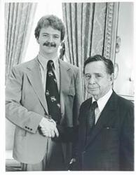 ["Black and white photograph print of Carl Albert posing with Chris Merrit."]