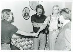 ["Black and white photograph print of Carl Albert with Susan Ford and unidentified people."]