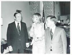 ["Black and white photograph print of Carl Albert standing with John Brademas and Susan Ford."]