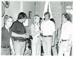 ["Black and white photograph print of Susan Ford standing with David Albert and three unidentified men."]