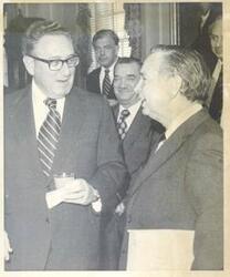 ["Black and white photograph print of Carl Albert speaking with Henry Kissinger before the breakfast meeting at the State Department in Washington."]