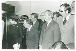 ["Black and white photograph print of Lindy Boggs, Carl Albert, John Rhodes, and others at the Centennial Safe Opening Ceremony"]