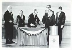 ["Black and white photograph print of Warren Burger, Carl Albert, Nelson Rockefeller, Gerald R. Ford, John Warner, and another man at the Bicentennial Ceremony at the National Archives. July 2, 1976"]