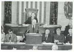 ["Black and white photograph print of Carl Albert at the anniversary of the First Continental Congress. Alistaire Cooke is speaking. September 25, 1974"]