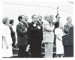 ["Black and white photograph print of Pat Nixon, Carl Albert, Richard M. Nixon, William P. Rogers, John B. Connally, Lyndon B. Johnson, Lady Bird Johnson, and Spiro Agnew at the Lyndon B. Johnson library dedication."]