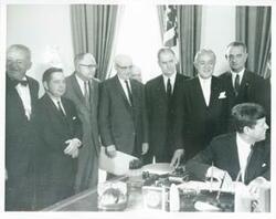 ["Black and white photograph print of Carl Albert, James O. Eastland, Lyndon B. Johnson, John F. Kennedy, and Hubert H. Humphrey with others at an unidentified function."]
