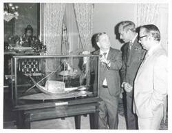 ["Black and white photograph print of Mosharaff Hossain Khan presenting Carl Albert a silver replica of the river boat which is their national symbol. July 1, 1976"]