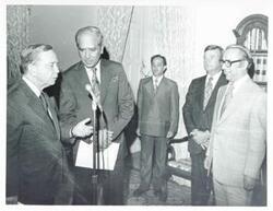 ["Black and white photograph print of Carl Albert speaking into a microphone during the Bangladesh trip. July 1, 1976"]