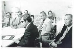 ["Black and white photograph print of Clement Zablocki and other men seated at a round table."]