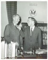 ["Black and white photograph print of Carl Albert shaking hands with Major Bernard F. Fisher, winner of the Congressional Medal of Honor. February 20, 1967"]