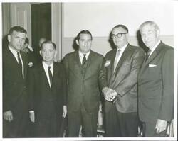 ["Black and white photograph print of Carl Albert posing with Fred Harris, Mike Monroney and two other men."]