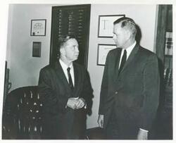 ["Black and white photograph print of Carl Albert talking with Dewey Bartlett. 1960s."]