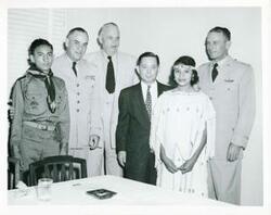 ["Black and white photograph print of Carl Albert standing with unidentified men."]