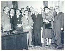 ["Black and white photograph print of Mike Monroney, Ed Edmondson, Toby Morris, John Jarman, Carl Albert, Sam Rayburn, Tom Steed, and others posing for a picture."]