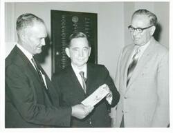 ["Black and white photograph print of Carl Albert posing with unidentified men."]