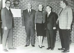 ["Black and white photograph print of Carl Albert posing with four unidentified people."]