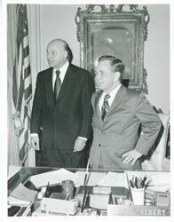["Black and white photograph print of Carl Albert posing with four unidentified people."]