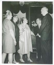 ["Black and white photograph print of John W. McCormack, Carl Albert, and Gerald R. Ford talking with three unidentified women. (Ford not shown in 2352)"]