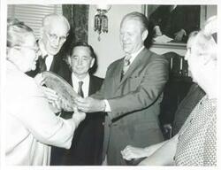 ["Black and white photograph print of John W. McCormack, Carl Albert, and Gerald R. Ford talking with three unidentified women. (Ford not shown in 2352)"]