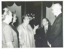 ["Black and white photograph print of John W. McCormack, Carl Albert, and Gerald R. Ford talking with three unidentified women. (Ford not shown in 2352)"]