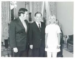 ["Black and white photograph print of Carl Albert posing with an unidentified man and woman."]