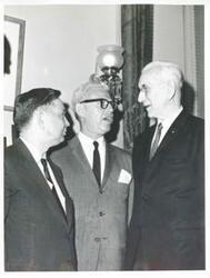["Black and white photograph print of Carl Albert talking with Goldberg and John W. McCormack."]
