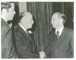 ["Black and white photograph print of Carl Albert in various poses with unidentified people."]