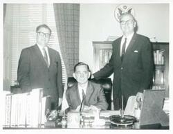 ["Black and white photograph print of Carl Albert in various poses with unidentified people."]