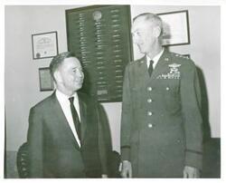 ["Black and white photograph print of Carl Albert in various poses with unidentified people."]