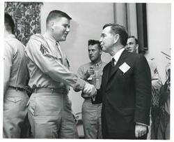 ["Black and white photograph print of Carl Albert in various poses with unidentified people."]