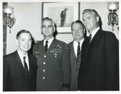 ["Black and white photograph print of Carl Albert posing with General William Westmoreland, Hale Boggs, and Ernest Hollings."]