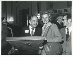["Black and white photograph print of Carl Albert with various unidentified people during his birthday, 1976"]