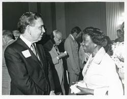 ["Black and white photograph print of Carl Albert with various unidentified people during his birthday, 1976"]