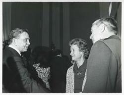 ["Black and white photograph print of Carl Albert speaking with unidentified people at his birthday party, 1976"]