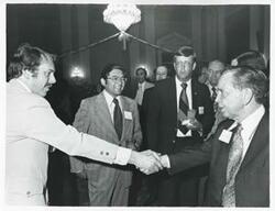 ["Black and white photograph print of Carl Albert speaking with unidentified people at his birthday party, 1976"]