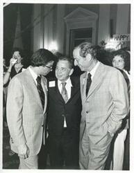 ["Black and white photograph print of Carl Albert standing with Joel Jankowsky and Julian Rothbaum at Albert's birthday party, 1976"]