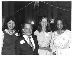 ["Black and white photograph print of Carl Albert standing with Kathy Kwock, Debbie Cline, and Loise Butler at his birthday party, 1976"]