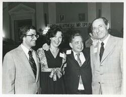 ["Black and white photograph print of Carl Albert posing with Joel Jankowsky, Jane Lawton England, and Julian Rothbaum at Albert's birth party."]