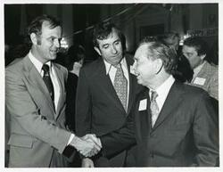 ["Black and white photograph print of Carl Albert shaking hands with an unidentified man at his birthday party, 1976"]