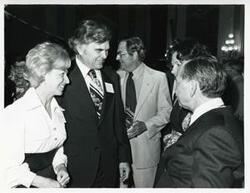 ["Black and white photograph print of Carl Albert talking with Mr. and Mrs. Al Ullman at his birthday party, 1976"]