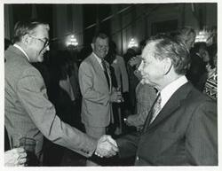 ["Black and white photograph print of Carl Albert with various unidentified people at his birthday party, 1976"]