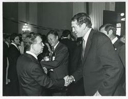 ["Black and white photograph print of Carl Albert with various unidentified people at his birthday party, 1976"]