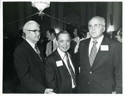 ["Black and white photograph print of Carl Albert standing with Tom Steed and another man at his birthday party, 1976"]