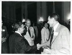 ["Black and white photograph print of Carl Albert shaking hands with Congressman John McFall at his birthday party, 1976"]