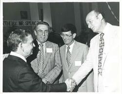 ["Black and white photograph print of Carl Albert shaking hands with Ed Koch at his birthday party, 1976"]